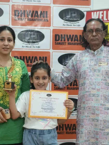 A student, her mother, and our senior guru celebrating her art award.