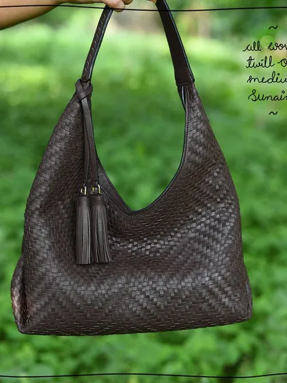 The Medium Sunaina hobo bag in our All Woven Twill Oak edit. The entire bag is hand-woven from our classic dark brown Oak leather, giving it a beautiful texture while remaining soft and lightweight.