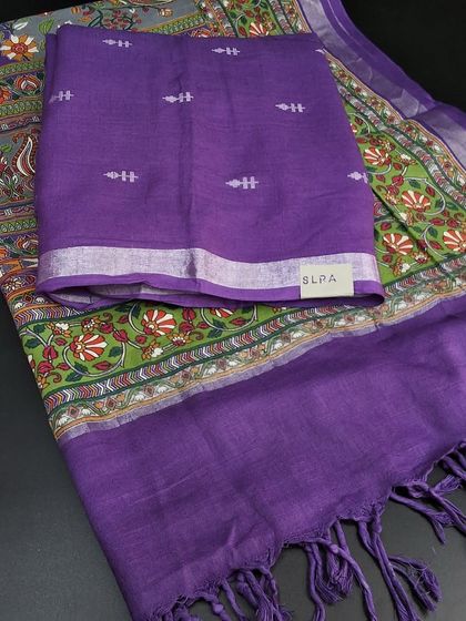 A festive linen cotton dress material in a striking purple and green combination. The top fabric has small woven motifs, paired with a vibrant printed dupatta.
