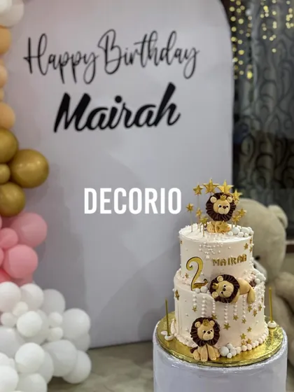 A detailed shot of the two-tiered lion-themed cake, perfectly complementing the teddy bear backdrop for Mairah's birthday.