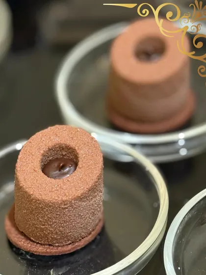 A little bit of cocoa couture. This individual chocolate mousse dessert has a velvety texture and a rich, deep flavor, making it a perfect bite of luxury.