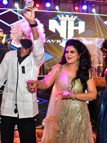 Dr. Gulati dancing with a guest on stage. My entertainers do more than just serve drinks; they become part of the celebration, adding to the overall energy and fun.