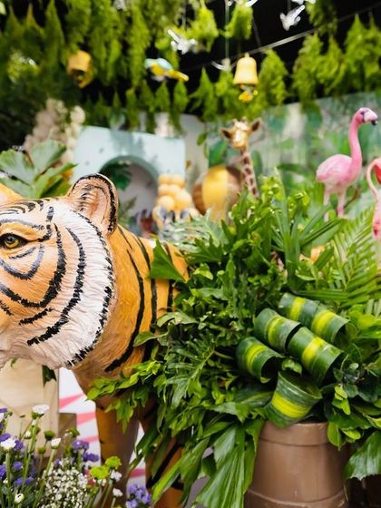 A detailed shot of the tiger prop at Eshaan's safari party, showcasing its realistic features and how it's placed within the floral and foliage arrangements.