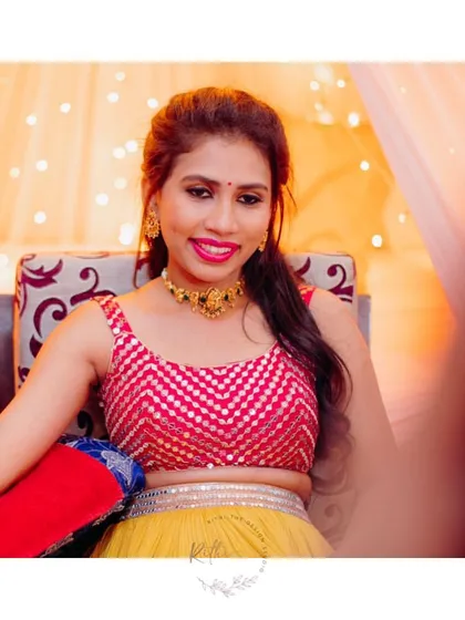 A happy client during her Mehendi ceremony, wearing our vibrant multi-colored lehenga with a pink sequined crop top.