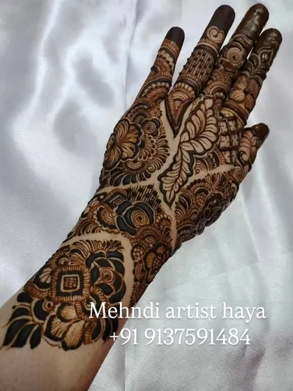 A striking design that uses a mix of bold, dark elements and delicate line work. The contrast creates a dynamic and eye-catching piece of bridal art.