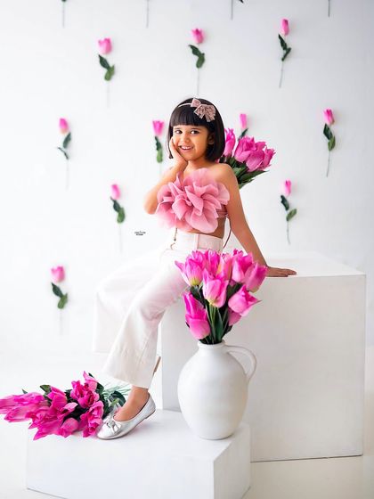 A sweet, shy smile from this little girl during her fifth birthday photoshoot. The pink floral theme is so pretty.