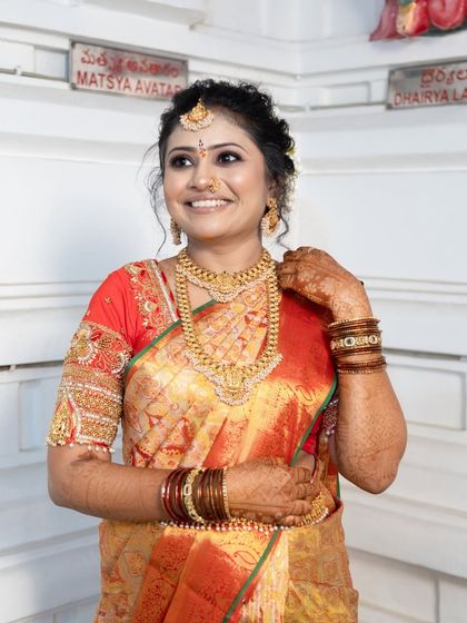 A happy customer looking radiant for her special occasion in one of my South Indian temple sets. Her smile says it all.