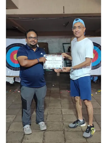 An adult student proudly holding his certificate after finishing our 10-day Archery Summer Camp. It’s proof that our camps are a great starting point for all ages.