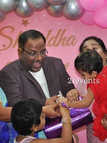 A candid moment of gift-giving at the butterfly-themed birthday.