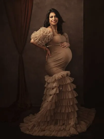 A full-length view that captures the grandeur of the moment. The flowing gown and confident pose create a powerful and elegant statement.