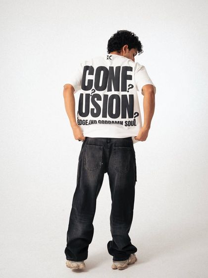 A back-focused shot for streetwear brand Klaimn. This highlights the bold graphic print on the t-shirt, which is a key selling point for the product.