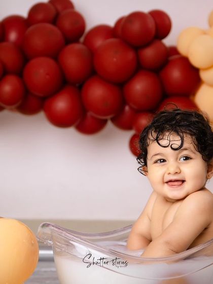 A big, cheerful smile from the birthday boy during his splash session.