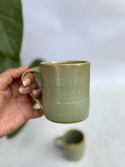 Holding one of our Green Celadon mugs. It's a great, sturdy mug for your daily caffeine fix.