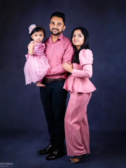 A full-length family portrait showcasing their coordinated pink attire. This standing pose creates an elegant and formal family photograph.