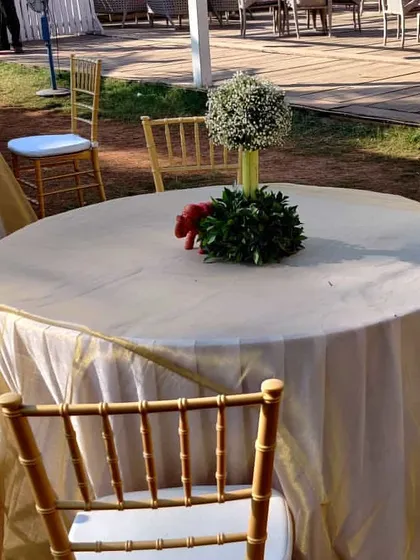 A simple and elegant centerpiece for a guest table. A small bouquet of baby's breath in a glass vase adds a touch of freshness without overwhelming the space.