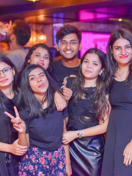 Friends making fun poses for the camera. It's all about creating a space where people feel comfortable and have a great time.