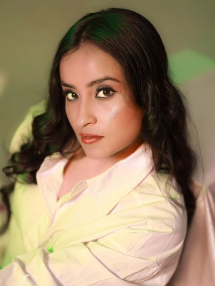 A close-up beauty shot with creative gel lighting. The mix of yellow and green light adds an artistic and moody feel to this portrait.