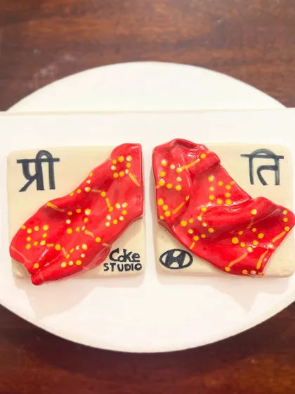 A close-up of the finished and glazed custom tiles. The vibrant red and yellow dots of the bandhani pattern came out beautifully from the kiln, bringing the memory to life in ceramic form.