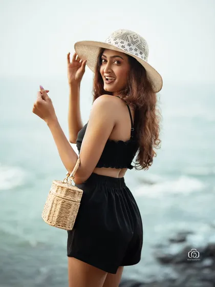 Another cheerful portrait from the beach, with the model smiling at the camera. This type of shot is perfect for capturing the carefree spirit of a summer holiday.