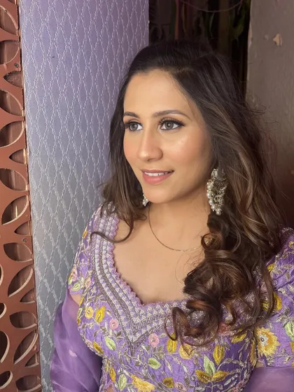 A portrait showing the complete look, with soft waves and a radiant, glowing complexion.