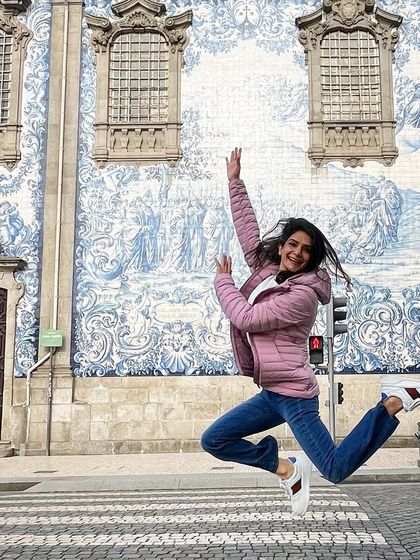 Leaping for joy in front of the beautiful blue walls of Porto, Portugal. Travel inspires me and fills me with energy, and I often find myself wanting to dance through new streets.