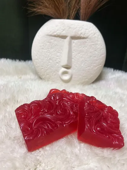 A pair of my handcrafted Red Wine soaps, with their rich color and intricate design. They make a luxurious addition to any bathroom.