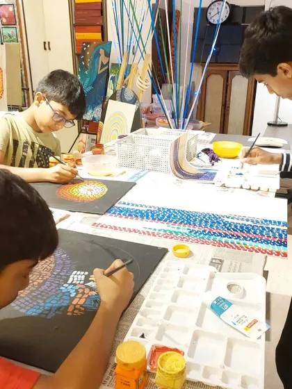 Concentration is key. These older students are meticulously working on their dot mandalas, a project that requires both patience and precision.