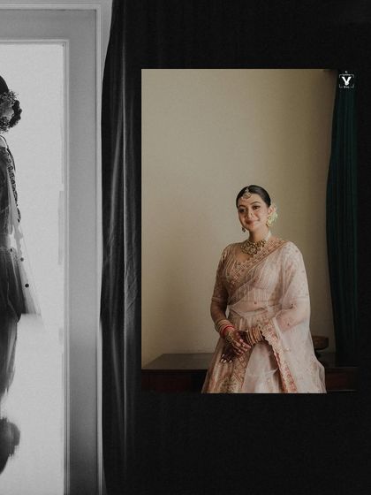 An artistic portrait using reflections and framing to create a multi-layered image of the bride. The mix of color and monochrome adds depth and a sense of looking into a memory.