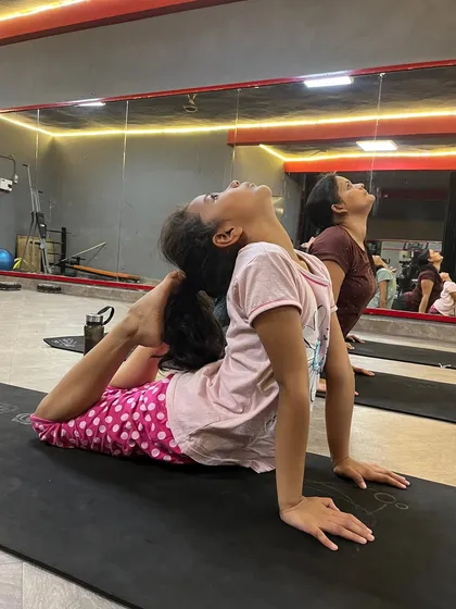 A young student in Eka Pada Rajakapotasana, showing that flexibility can be developed at any age.