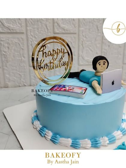 Another angle of the workaholic-themed cake, showing the "Happy Birthday" topper and the cute fondant character.