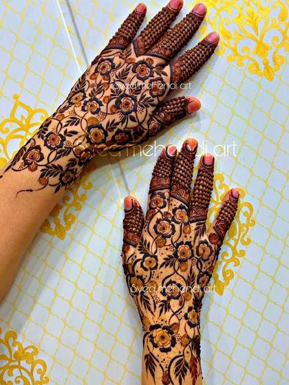 A delicate floral net design covering the hands, perfect for a party.