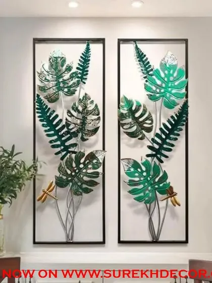 Bring the outdoors in with this set of two metal wall art panels. Each panel features a collection of lush green monstera and fern leaves, handcrafted to create a vibrant, botanical display that enlivens any wall.