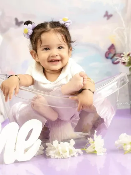 A perfect pose with her feet up. This little one is a natural model during her lavender butterfly-themed first birthday shoot.