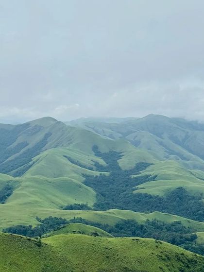 A classic landscape shot of the green, rolling hills of the Kudremukh range, as seen from the Gangadikal trek.