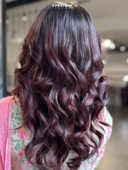 When your hair color does all the talking. Serving luxe waves in a dreamy, deep burgundy hue.