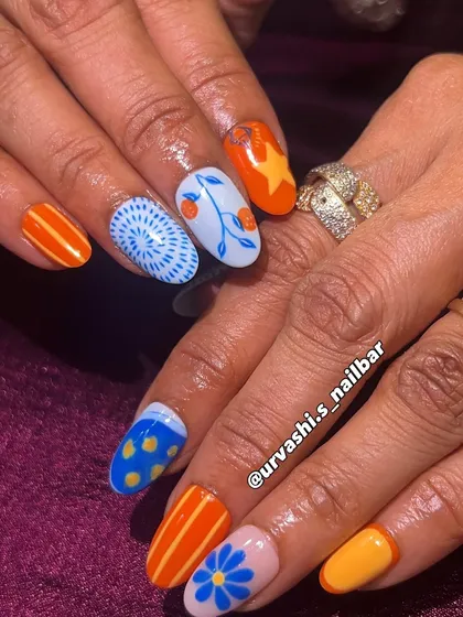 A funky and artistic set with a mix of hand-painted patterns. The combination of bright orange and blue with florals, stripes, and geometric designs creates a bold and unique pop of color.