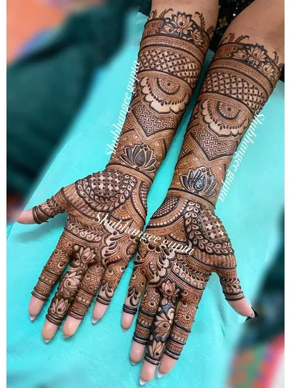 Another angle of this beautiful engagement mehndi, showing how the patterns flow seamlessly from the palm to the arm. The design is dense yet clear and elegant.