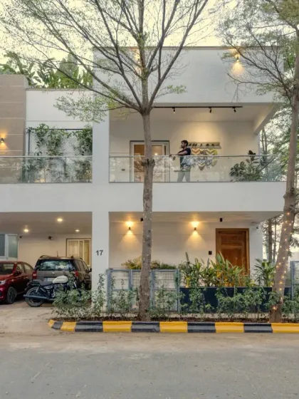 This is the first view of Villa 17, a contemporary two-storey home where I blended a clean white facade with lush greenery. My approach to architecture always considers how the structure interacts with its natural surroundings to create timeless curb appeal.