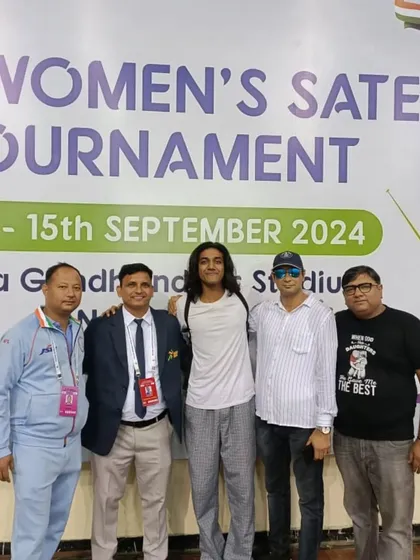 Our coaches and supporters with a fencer at the FIE Women's Satellite Tournament. The support system behind each athlete is a crucial part of their journey.