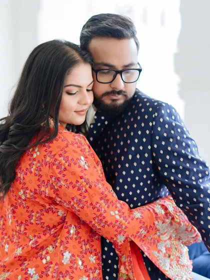 An intimate portrait of a couple, their faces close, capturing a moment of quiet connection and affection.