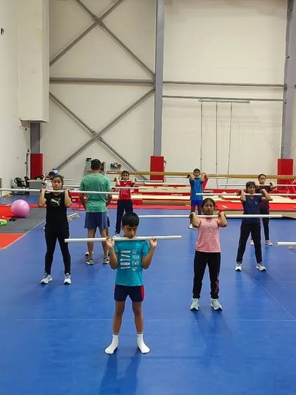 A group of future champions learning the proper form for a squat. Building these solid foundations now will pay dividends throughout their athletic careers.