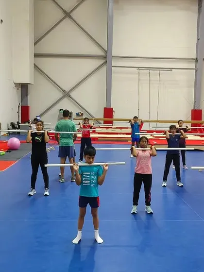 A group of future champions learning the proper form for a squat. Building these solid foundations now will pay dividends throughout their athletic careers.