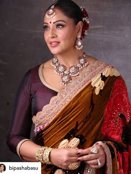 A detailed close-up portrait of Bipasha Basu. This highlights the intricate work of her makeup artist and jewelers, which we always credit.