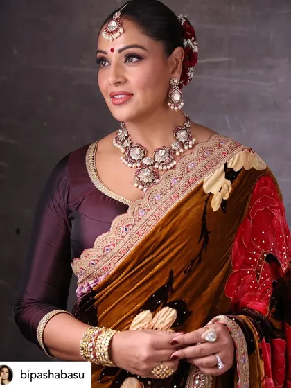 A detailed close-up portrait of Bipasha Basu. This highlights the intricate work of her makeup artist and jewelers, which we always credit.