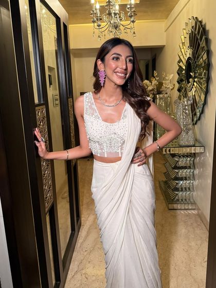A stunning guest in an ivory saree. I gave her my signature glowing skin and a soft eye, with a pop of color from her pink earrings for a modern touch.