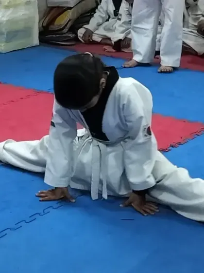 Flexibility is a cornerstone of Taekwondo. We guide our students, even the youngest ones, to safely develop incredible flexibility, like achieving a full split, which is crucial for advanced kicks.