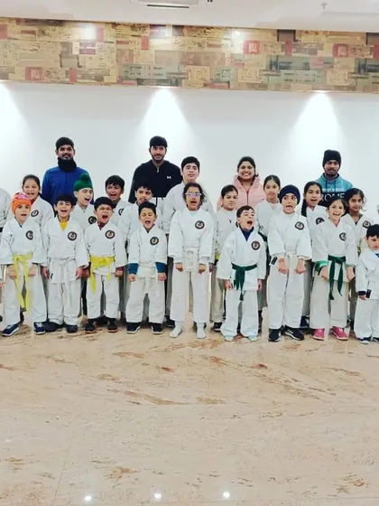 A large group of our young karate students posing for a photo. We are a growing family, united by our passion for karate.