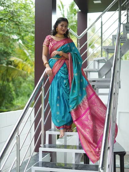 This full-length photo captures the grace of the traditional Nauvari saree. The client is posing on the modern staircase of the outdoor studio, creating a beautiful contrast between contemporary architecture and classic attire.
