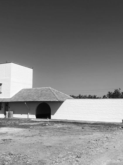 An early construction photo of the Hassan farmhouse, showing the basic form of the building before the landscape and finishes were completed.