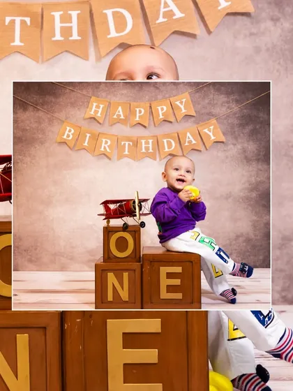 A creative collage for a first birthday, with the baby boy peeking over 'ONE' blocks under a 'Happy Birthday' banner.